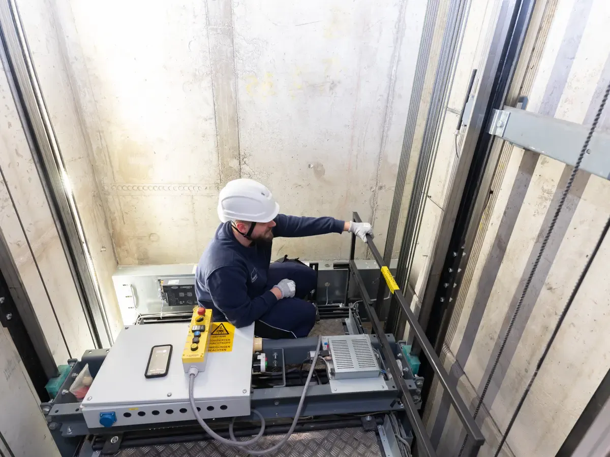 Technician repairs an elevator
